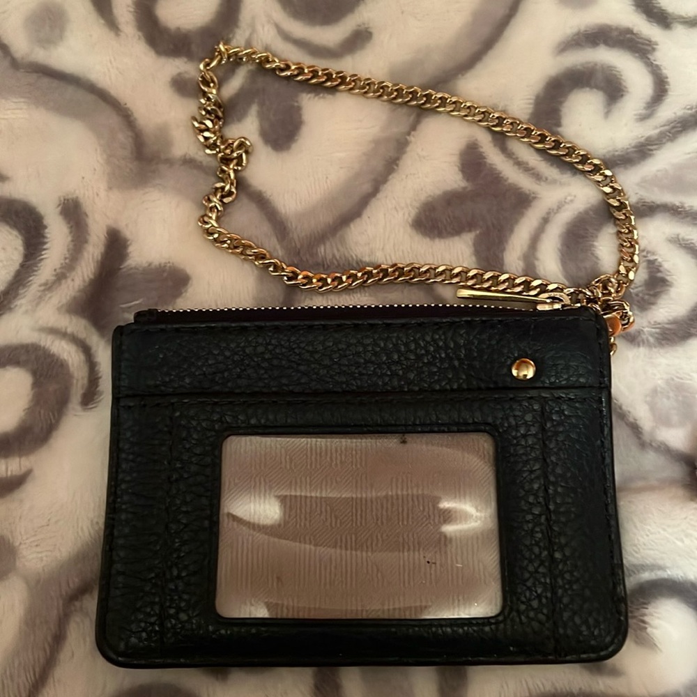 Michael Kors Wristlet with a gold detachment chain.